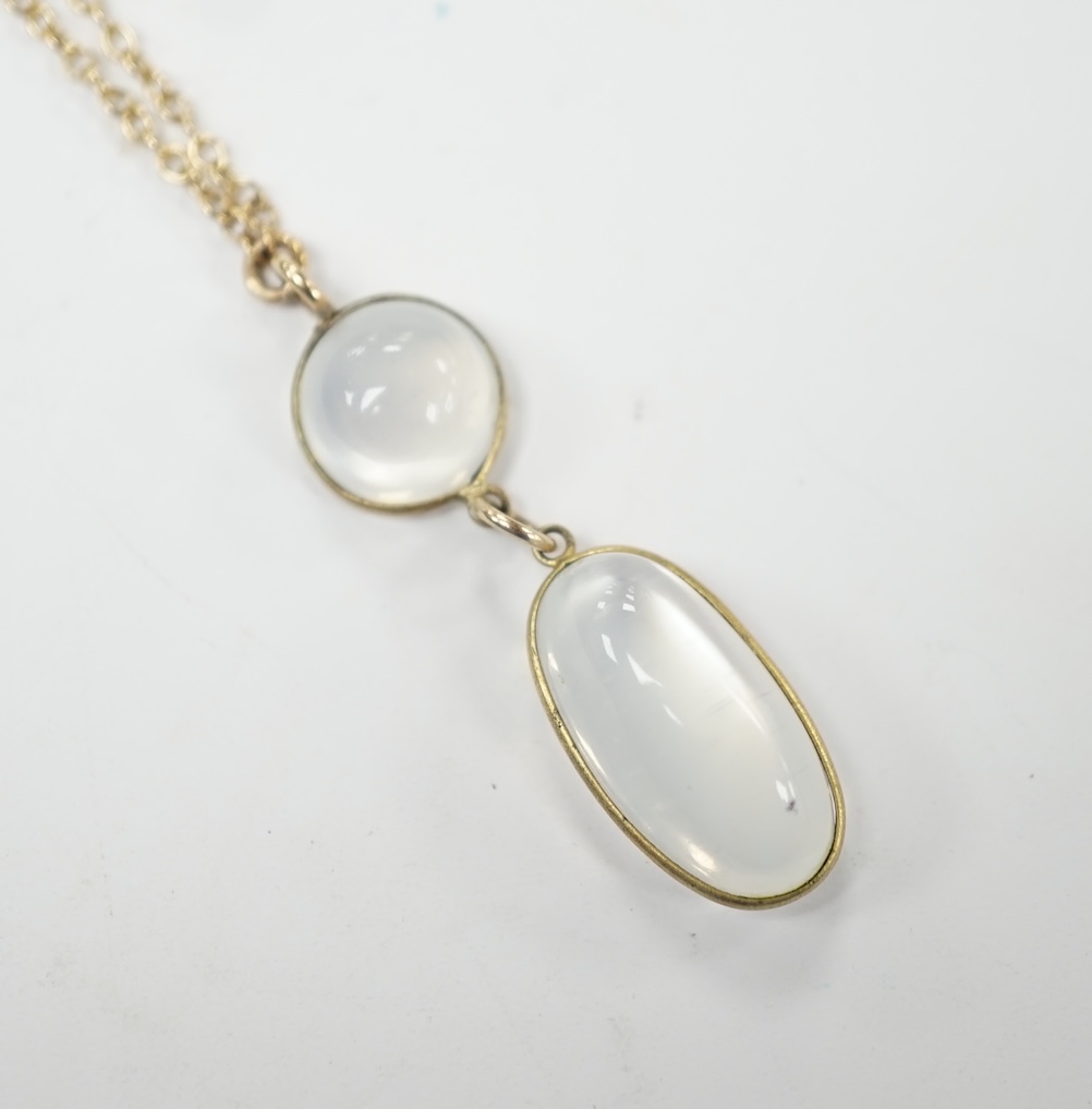 A modern 9ct gold and two stone cabochon moonstone set drop pendant necklace, overall, 47cm, gross weight 3.8 grams. Good condition.